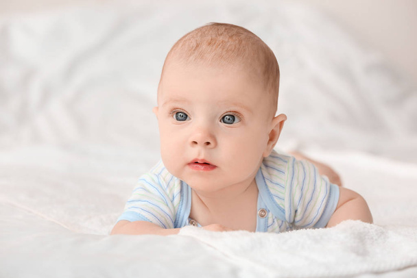 Portrait of cute little baby lying on bed - Photo, image