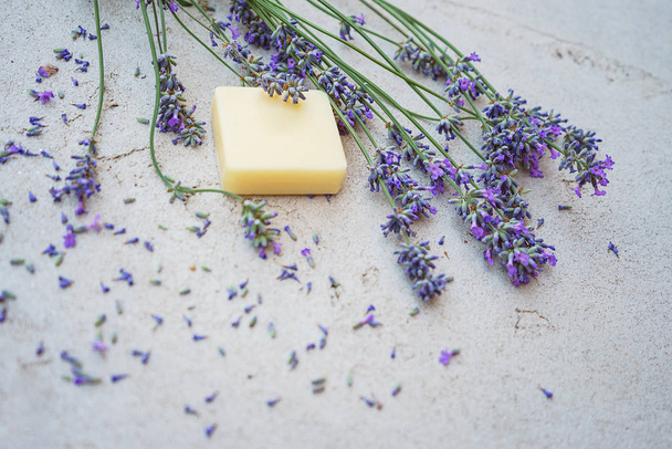 Lavender flowers and natural soap for bodycare on concrete background. - Foto, Imagen