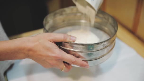 Baker sifting wheaten flour and preparing dough for making cake - Metraje, vídeo