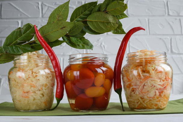 Fermented foods. Sauerkraut, salted tomatoes on a white background. Vegetarian food. - Photo, Image