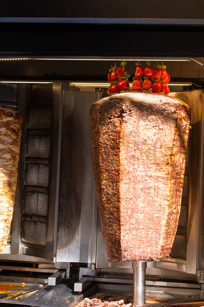 Traditional Turkish food Doner Kebab. Turnspit skewing kebap shawarma - Photo, Image