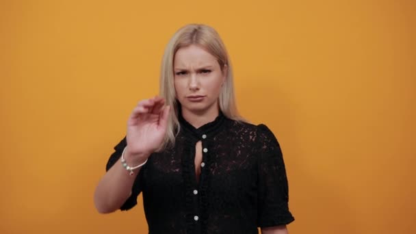 girl in black dress an irritated woman shows off hands which symbolize the stop - Footage, Video