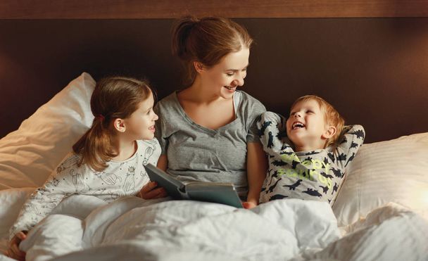 evening family reading. mother reads children . book before goin - Фото, зображення
