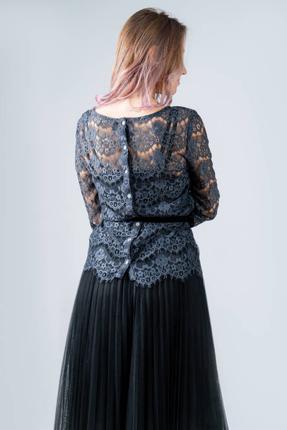 Girl in a black t-shirt, black skirt, in a lace jacket isolated on a white background. - Foto, Imagen