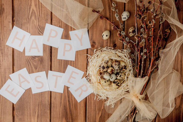 Flat lay composition of quail eggs and card with text Happy Easter on wooden table. Top view. - Valokuva, kuva
