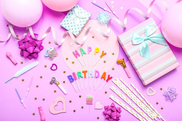 Colorful celebration background with various party confetti, balloons, gifts, and decoration on pink background. - Photo, Image