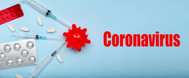 Medicines against Coronavirus model. Different pills, syringes, text CORONAVIRUS. long banner 2019 nCoV coronavirus on blue background. Wuhan virus, Chinese Coronavirus outbreak influenza. - Fotografie, Obrázek