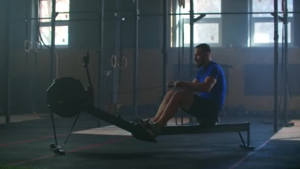 Fitness sporcusu kürek çekme makinesi eğitimi yoğun dayanıklılık egzersizi spor salonundaki güçlü sporcu fiziksel antrenmanı sağlıklı yaşam tarzı motivasyonu ellerinizi kapatın. yavaş çekim - Video, Çekim