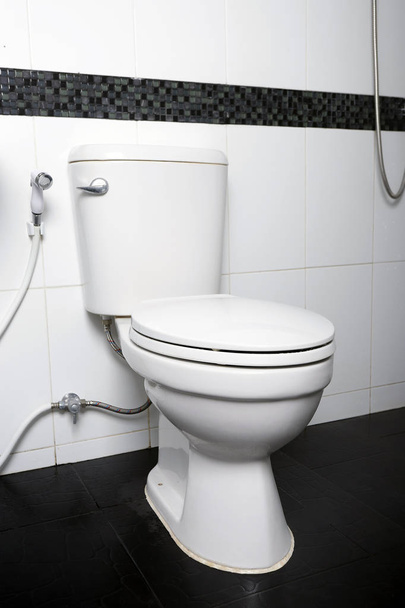White toilet bowl in the bathroom interior close-up. - Valokuva, kuva