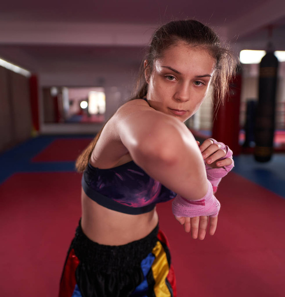 Kickboxer girl shadow boxing and kicking - 写真・画像