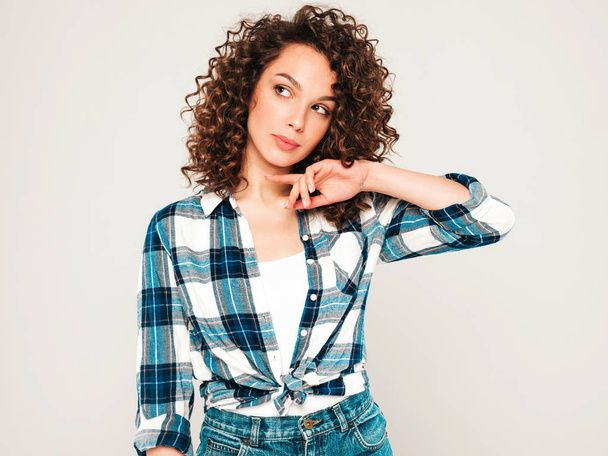 Portrait of beautiful smiling model with afro curls hairstyle dressed in summer hipster clothes.Sexy carefree girl posing in studio on gray background.Trendy funny and positive woman - Photo, image