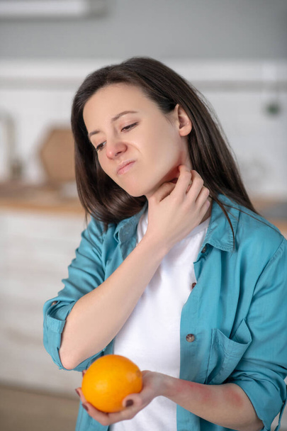 Woman having symptomes of being allergic to oranges - Fotó, kép