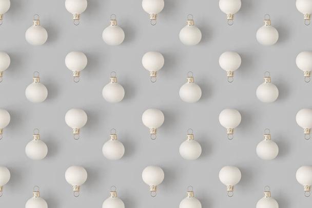 Christmas pattern with white baubles decoration on pastel gray background. Minimal holiday concept. - Photo, Image