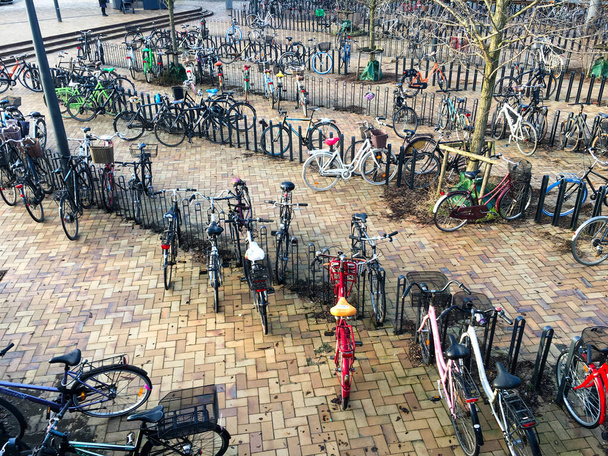 Bicycles in a parking lot in Copenhagen near one of the metro stations. And Copenhagen is sometimes called the bicycle capital of Europe. 2019 Odense. Denmark - Photo, Image
