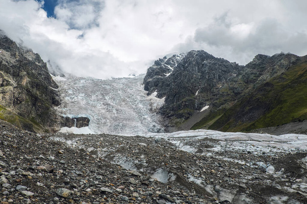 Amazing view to full Adishi glacier icefall and its small waterfall in mountains of Svaneti Georgia - 写真・画像
