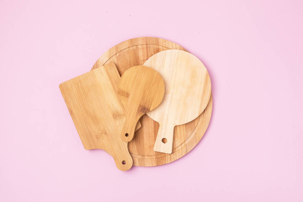 Variety of Multifunctional Circular Wooden Cutting Board for Cutting or Serve Pink Background Top View - Фото, изображение