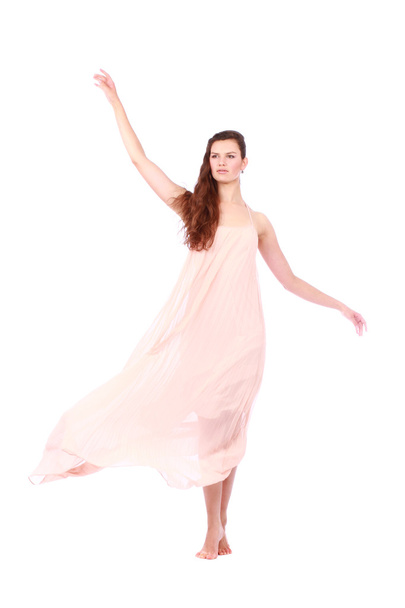 Graceful girl in flying light pink dress - Фото, изображение