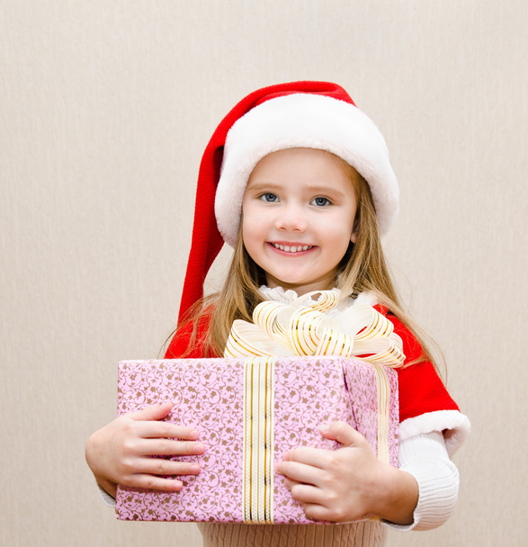 Happy smiling little girl with christmas present - 写真・画像
