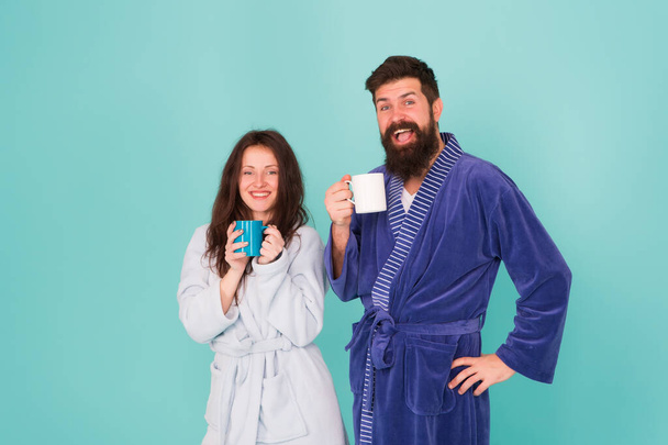 Vacation starting here. Hotel breakfast service. Coffee is our tradition. Man and woman happy together. Family traditions. Couple in cozy bathrobes enjoy lazy weekend. Drinking coffee. Spa and relax - Foto, afbeelding