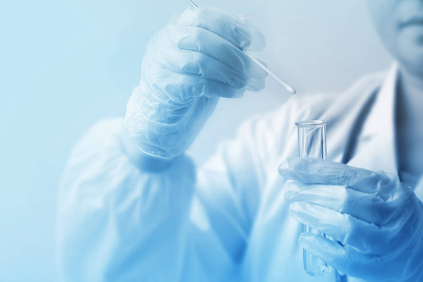laboratory assistant in gloves puts a sample for DNA analysis on - Photo, Image