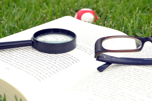 Book with glasses and magnifying glass - Photo, Image