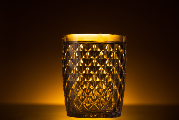faceted glass in dark with warm back light - Valokuva, kuva