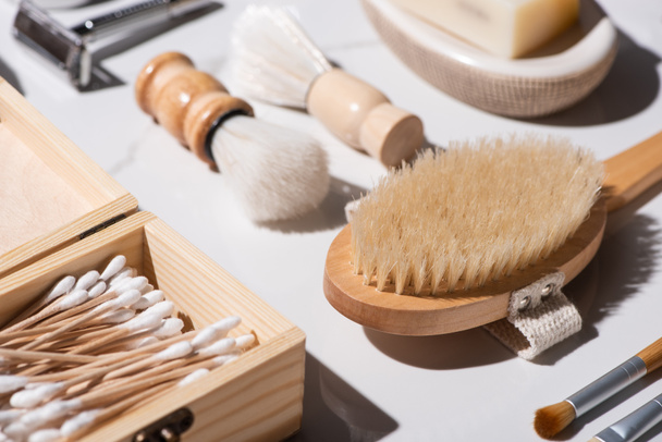 Selective focus of shaving brushes, box of ear sticks, Hair brush on white background, zero waste concept - Foto, Imagem