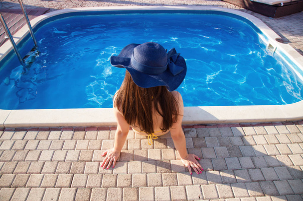 woman it hat relaxing at the pool - Photo, Image