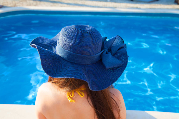 woman it hat relaxing at the pool - Photo, image