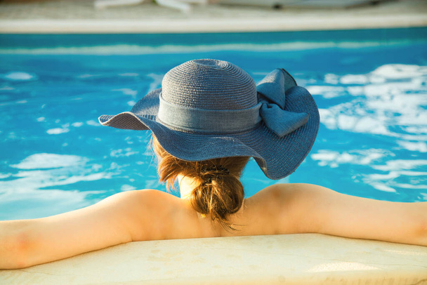 Summer day lifestyle woman relax near luxury swimming pool.  - Фото, зображення