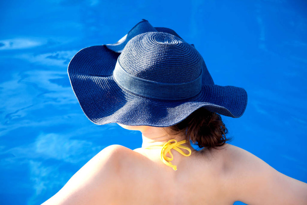 Summer day lifestyle woman relax near luxury swimming pool.  - Фото, зображення