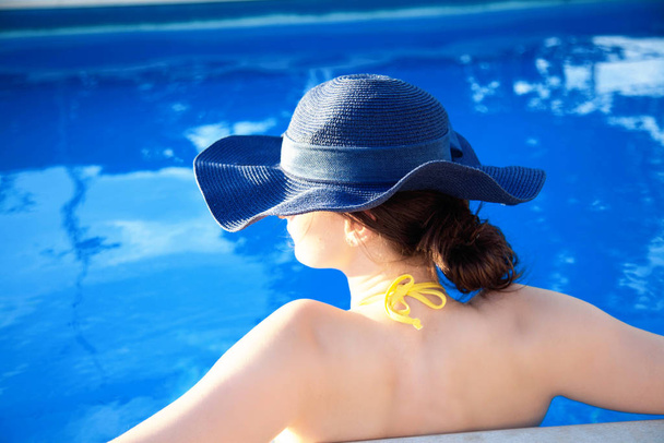 Summer day lifestyle woman relax near luxury swimming pool.  - Photo, Image