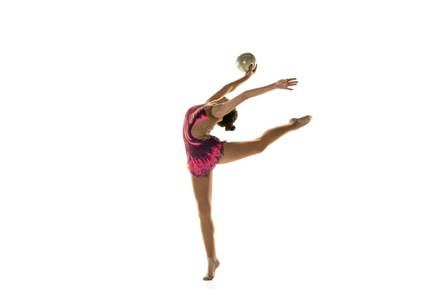 Young flexible female gymnast isolated on white studio background - Fotó, kép