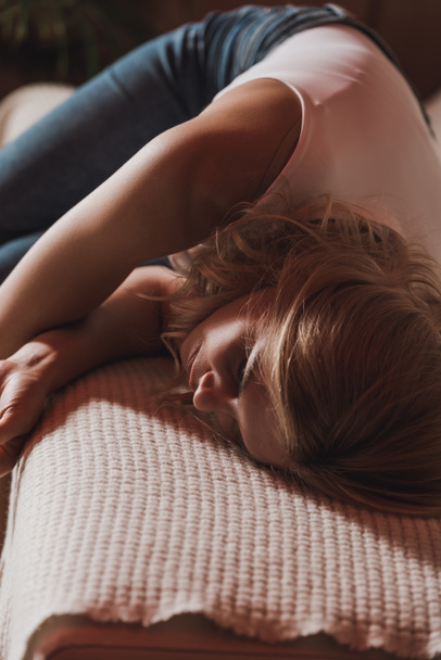 Selective focus of woman lying on sofa in room - Foto, Imagem