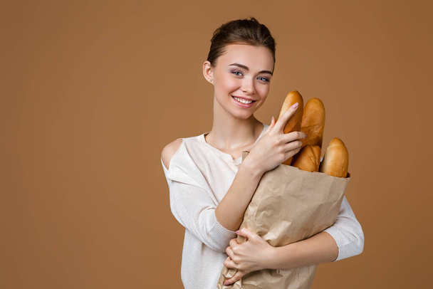 young woman holding bread - Fotó, kép