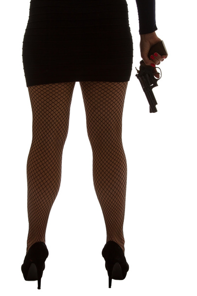 Legs of dangerous woman with handgun and black shoes silhouette - Photo, image