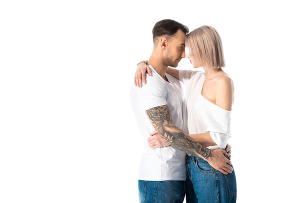 sexy young tattooed couple hugging isolated on white - 写真・画像