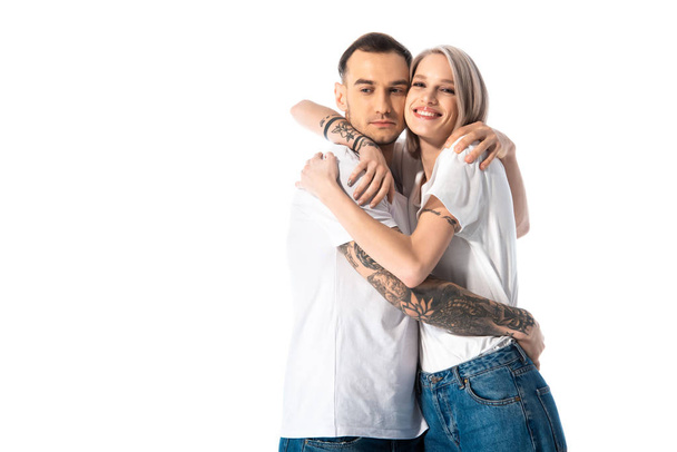 happy young tattooed couple hugging isolated on white - 写真・画像