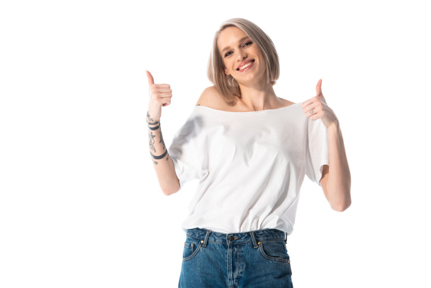 happy young tattooed girl showing thumbs up isolated on white - Foto, Imagen