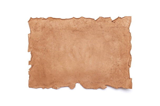 Ancient antique medieval damaged sheet of paper or parchment with ragged crumpled edges with copy space for text isolated on white background. - 写真・画像