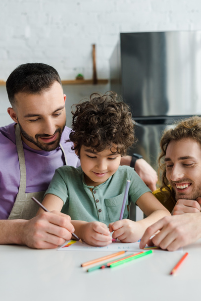 happy mixed race kid drawing near homosexual parents  - Photo, Image