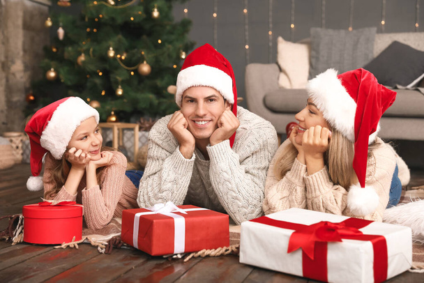 Happy family with Christmas gifts at home - Fotó, kép