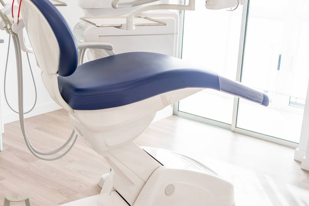 blue dentist armchair with instruments in white cabinet - Photo, Image