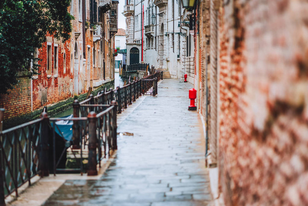 Venice, Italy. The small streets and narrow channel with colored brick houses on the shore of old city - Fotografie, Obrázek
