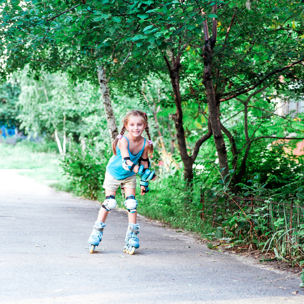 Little girl in roller skates - Fotó, kép