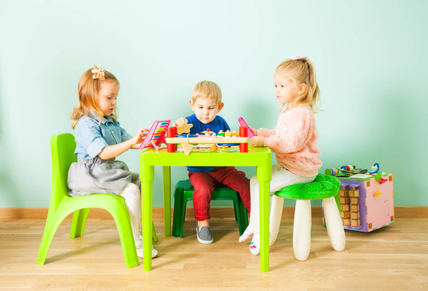 Cute little children playing in kindergarten room - Photo, Image