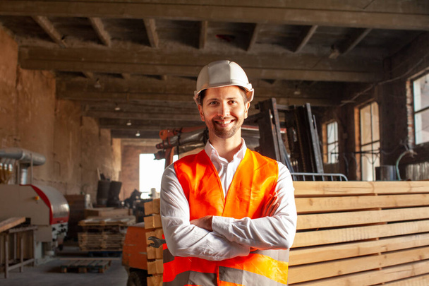 Young engineer in vest and hard hat - Foto, Bild