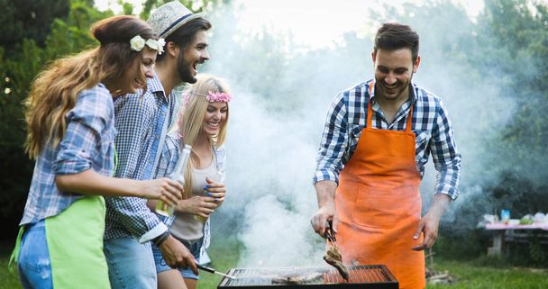 Happy people having camping and having bbq party outdoor - Foto, Imagem