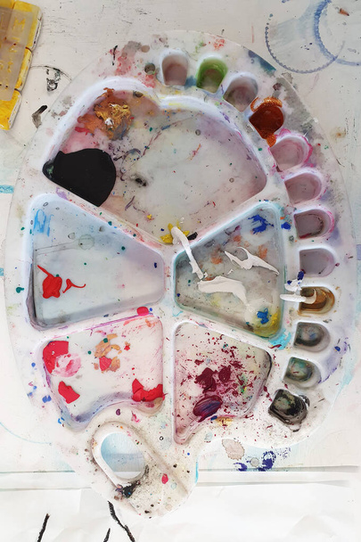 Top view of colorful used palette for painting. Art club or lessons concept. - 写真・画像