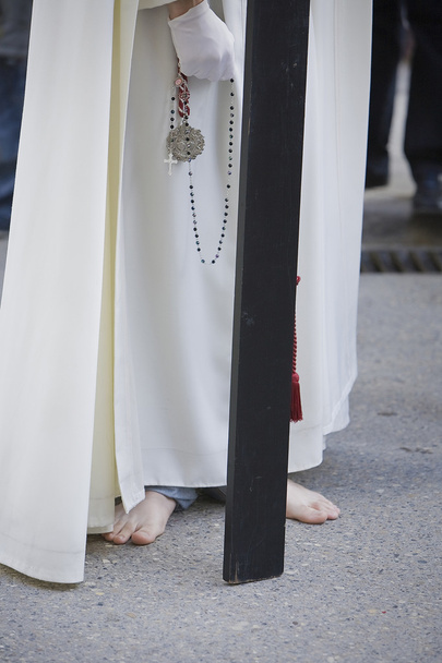 Barefoot penitent doing penance with a wood cross in a Holy week procession - Photo, Image